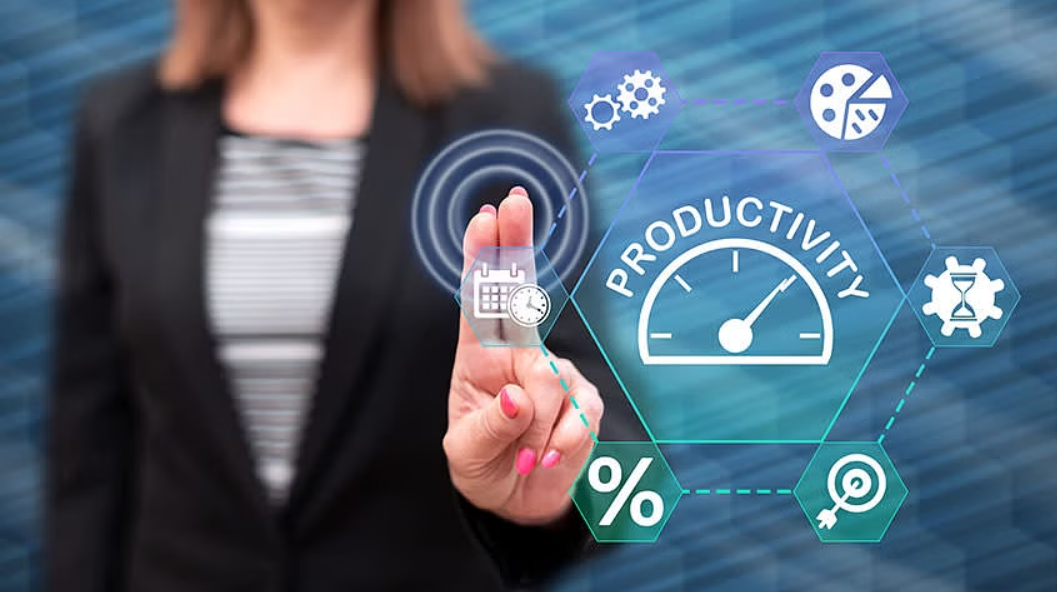 A businesswoman in a suit is interacting with a virtual touchscreen interface displaying icons related to productivity, including a speedometer labeled "PRODUCTIVITY," calendar, clock, gears, pie chart, hourglass, percentage, and target symbols—representing time management, performance optimization, and efficiency in a digital workplace.